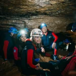 xplorando una cueva en la Costa Dorada con casco y frontal